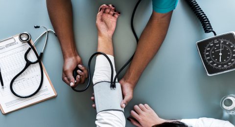 Nurse measuring patient blood pressure