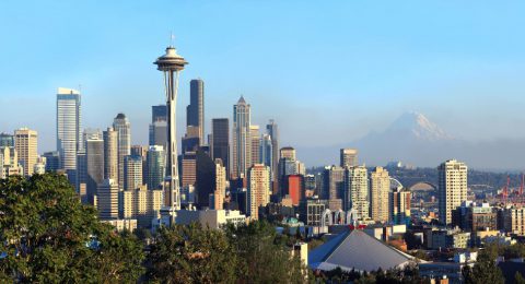 A panoramic view of Seattle Washington modern skyline buildings & mt. Rainier.