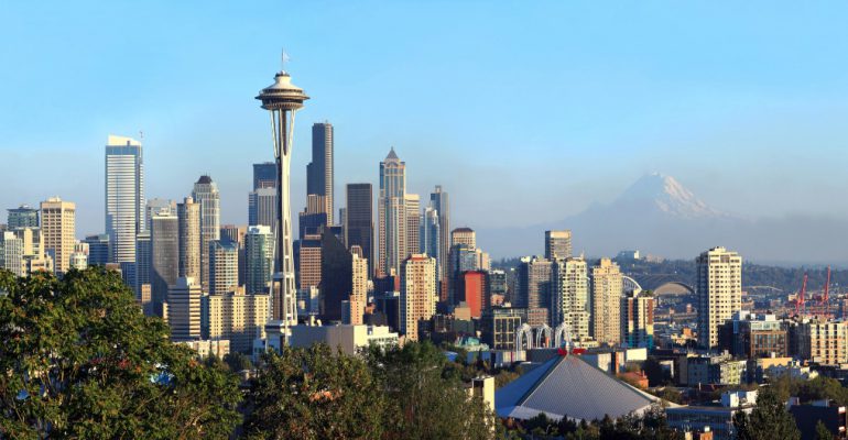 A panoramic view of Seattle Washington modern skyline buildings & mt. Rainier.